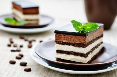 Opera cake on a light brown background. tinting. selective focus