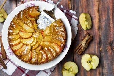 apple tart with caramel and cinnamon on wooden table