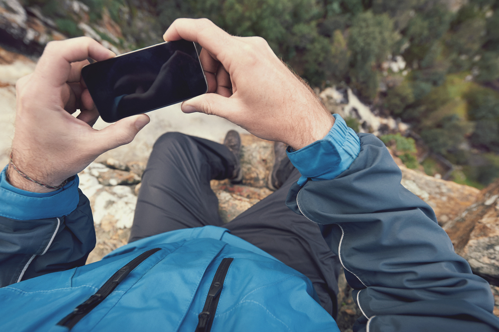 Adventure,Man,With,Gps,Device,Or,Phone,Outdoors,In,Wilderness