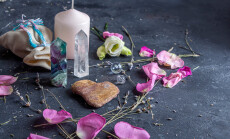 Magic,Composition,With,Pink,Candle,,Crystals,,Pagan,Bag,And,Flowers.