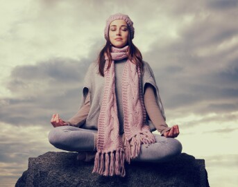 Young,Woman,Meditating,In,Nature,Sitting,On,The,Rock.
