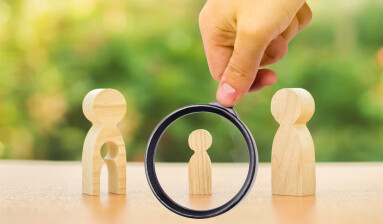A,Magnifying,Glass,Looks,At,A,Child's,Figure,Stands,Between