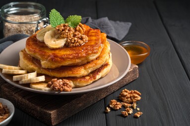 Homemade,Pancakes,With,Banana,,Honey,And,Nuts,On,A,Black