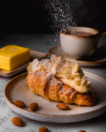 Traditional,French,Breakfast,Croissant,With,Almonds,On,Dark,Background