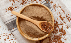 Raw,Flax,Seeds,Flour,In,A,Wooden,Bowl,With,A