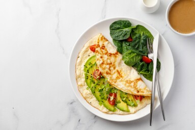 Stuffed,Egg,Omelette,With,Vegetable,,Avocado,,Tomatoes,On,White,Background