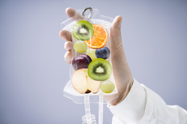 Male,Doctor,Holding,Saline,Bag,With,Fruit,Slices,Inside,In