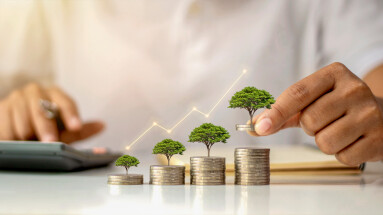 A,Businessman,Holding,A,Coin,With,A,Tree,That,Grows