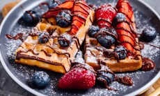 Belgian,Waffle,With,Chocolate,,Strawberry,,Blueberries,And,Powdered,Sugar,On