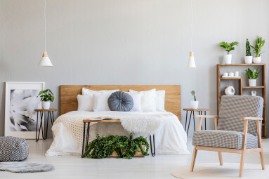 Patterned,Armchair,And,Plants,In,Bright,Bedroom,Interior,With,Poster