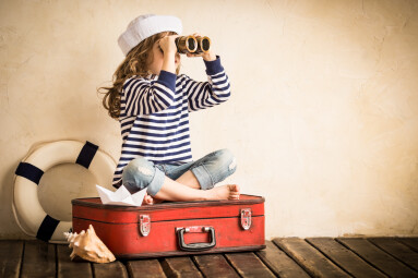 Happy,Kid,Playing,With,Toy,Sailing,Boat,Indoors.,Travel,And