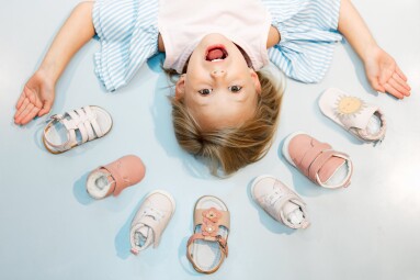 Child,,Shoes,And,Head,Above,Floor,With,Smile,On,Face