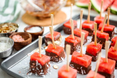 Preparing,Watermelon,Appetizers,Dipped,In,Chocolate,And,Sprinked,With,Sea