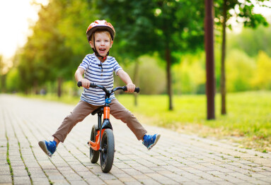 Happy,Child,Boy,Rides,A,Racetrack,In,Park,In,The