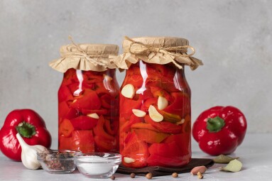 Pickled,Sweet,Peppers,With,Garlic,In,Two,Glass,Jar,On