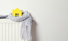 House,Model,Wrapped,In,Scarf,On,Radiator,Indoors,,Space,For