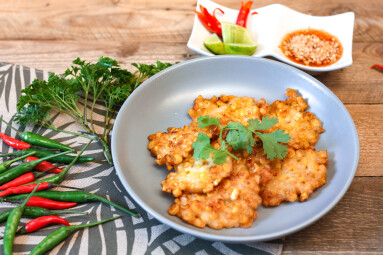Corn,Fritters,With,Chili,Sauce,Placed,On,A,Wooden,Table
