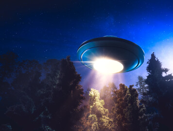 Low,Key,Image,Of,Ufo,Hovering,Over,A,Forest,At