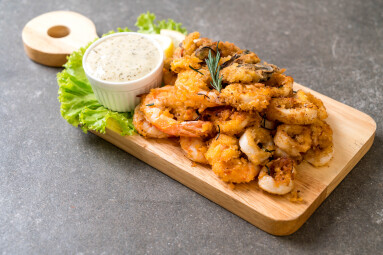 Fried,Seafood,(squids,,Shrimps,,Mussels),With,Sauce,On,Wooden,Board