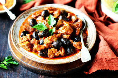 Beef,Stew,With,Olives,And,Tomatoes,On,A,Dark,Background,