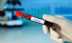 Scientist,Holding,Test,Tube,With,Blood,Sample,And,Label,Anemia