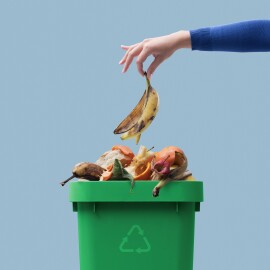 Woman,Putting,Organic,Biodegradable,Waste,In,A,Recycling,Bin,,Separate