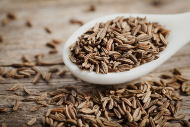 Cumin,Seeds,Or,Caraway,In,White,Spoon,On,Wooden,Board