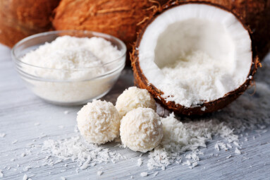 Candies,In,Coconut,Flakes,And,Fresh,Coconut,On,Color,Wooden