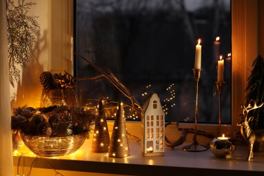 Many,Beautiful,Christmas,Decorations,,Candlesticks,And,Festive,Lights,On,Window