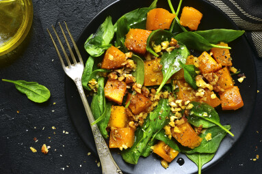 Roasted,Pumpkin,Salad,With,Spinach,And,Walnut,On,A,Black