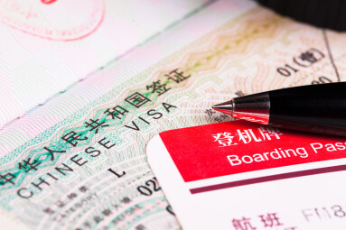 China,Visa,In,Passport,And,Boarding,Pass