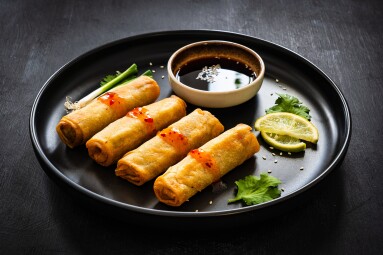 Vegetable,Filled,Spring,Rolls,And,Soy,Sauce,On,Black,Wooden