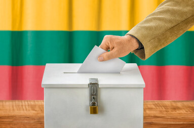 Man,Putting,A,Ballot,Into,A,Voting,Box,-,Lithuania