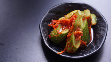 Cucumber,Kimchi,(oi-sobagi),In,A,Black,Bowl,Isolated,On,A