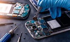 The,Asian,Technician,Repairing,The,Smartphone's,Motherboard,In,The,Lab