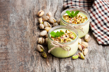 Natural,Pistachio,Yogurt,In,A,Small,Glass,Jar,On,Wooden