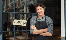 Portrait,Of,Small,Business,Owner,Smiling,And,Standing,With,Crossed