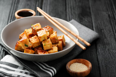 Fried,Tofu,With,Sesame,Seeds,And,Spices,On,Black,Background.