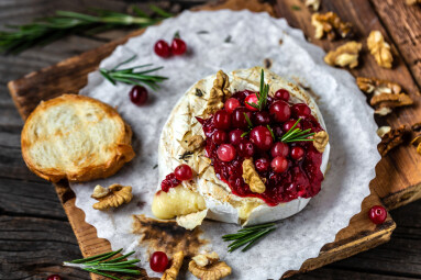 Baked,Camembert,With,Cranberry,Sauce,,Baguette,Bread,And,Rosemary,On