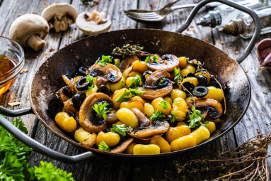 Gnocchi,With,Fried,White,Mushrooms,On,Wooden,Table