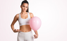 Beautiful,Young,Woman,Holding,A,Pink,Balloon