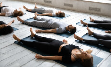 Young,Sporty,People,With,Closed,Eyes,Meditating,In,Savasana,Pose