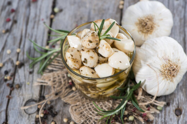 Preserved,Garlic,With,Fresh,Herbs,On,Vintage,Background