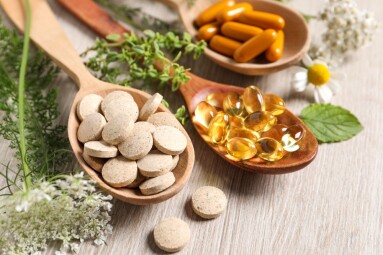 Different,Pills,,Herbs,And,Flowers,On,Wooden,Table,,Closeup.,Dietary