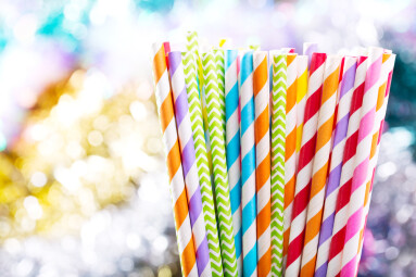 Colorful,Drinking,Striped,Straws,On,Colorful,Background