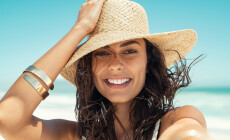 Close,Up,Face,Of,Happy,Young,Woman,With,Straw,Hat