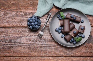 Delicious,Glazed,Curd,Snacks,With,Blueberries,On,Wooden,Table,,Flat