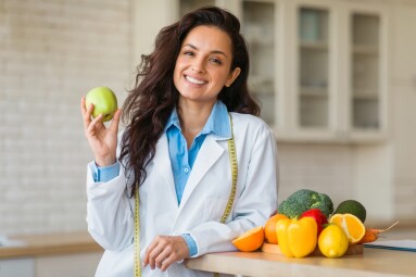 Cheerful,Female,Nutrition,Adviser,With,Green,Apple,And,Tape,Measure