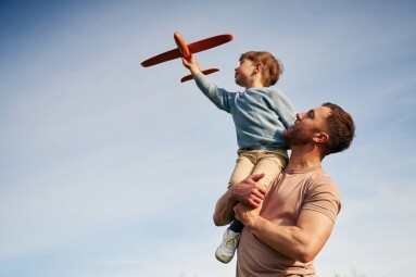 Blue,Sky,With,White,Cloud.,Father,Is,Holding,Son,That