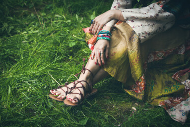 Woman,Legs,On,Grass,In,Strap,Flat,Sandals,And,Boho